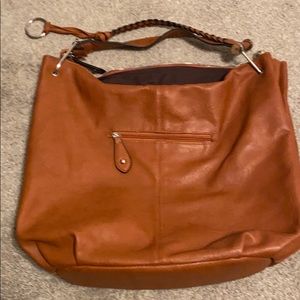 Tan purse missing a circle on top